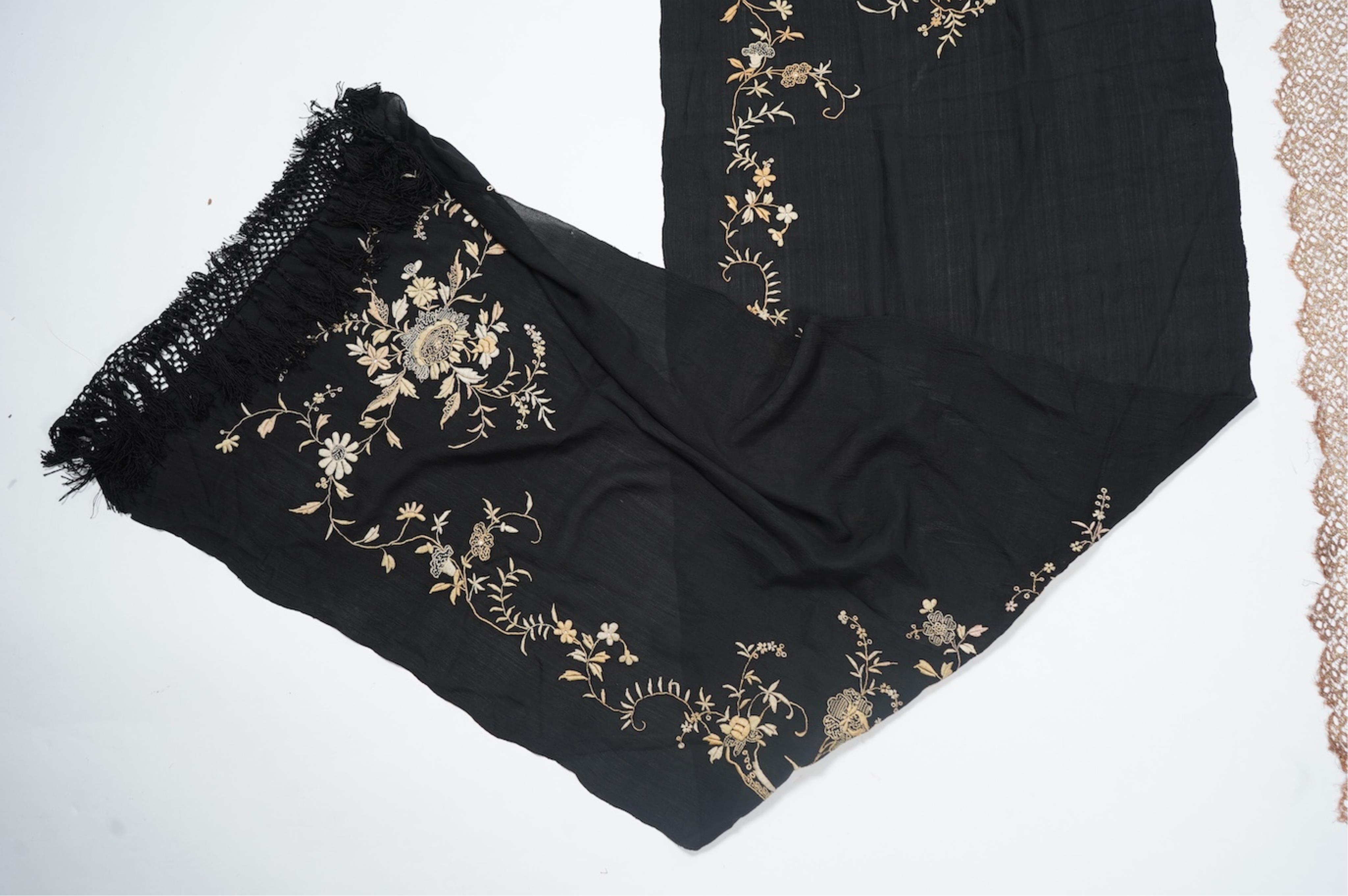 An Art Deco black silk floral embroidered shawl, using tones of red and orange with gold highlights, bordered with bronze metallic lace, together with a black crepe and yellow silk embroidered stole. Art Deco stole, 142c